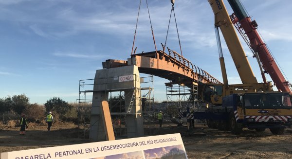 Comienza la instalación de los primeros tramos de la pasarela de madera sobre el río Guadalhorce